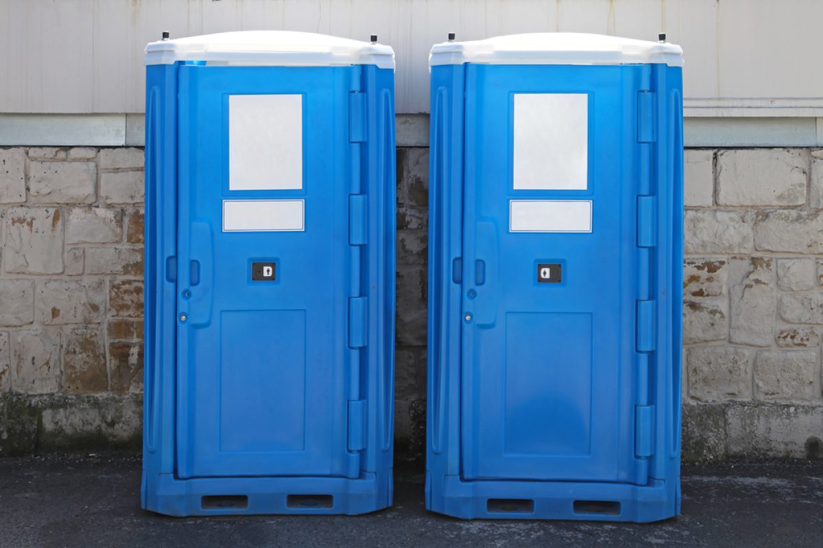 Two,Portable,Toilet,Cabins,At,Construction,Site