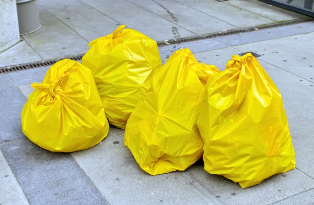 Four,Yellow,Garbage,Bags,On,The,Street