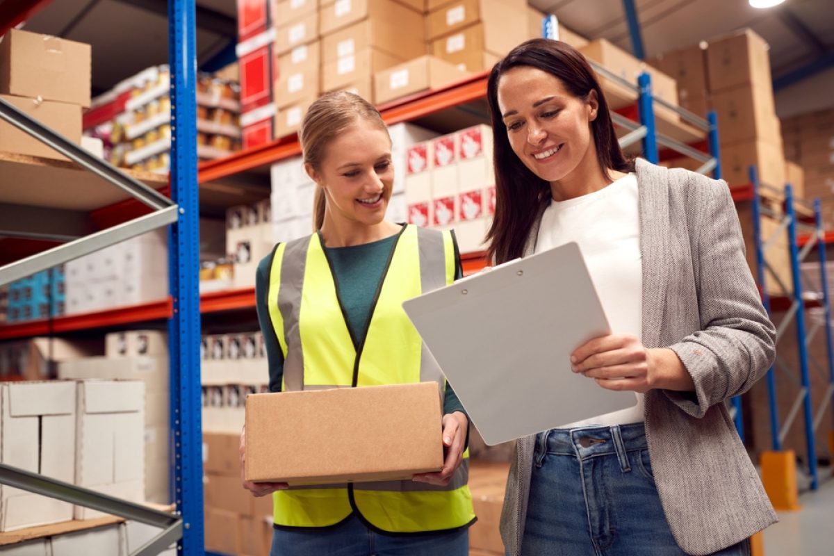 Female,Team,Leader,With,Clipboard,In,Warehouse,Training,Intern,Standing